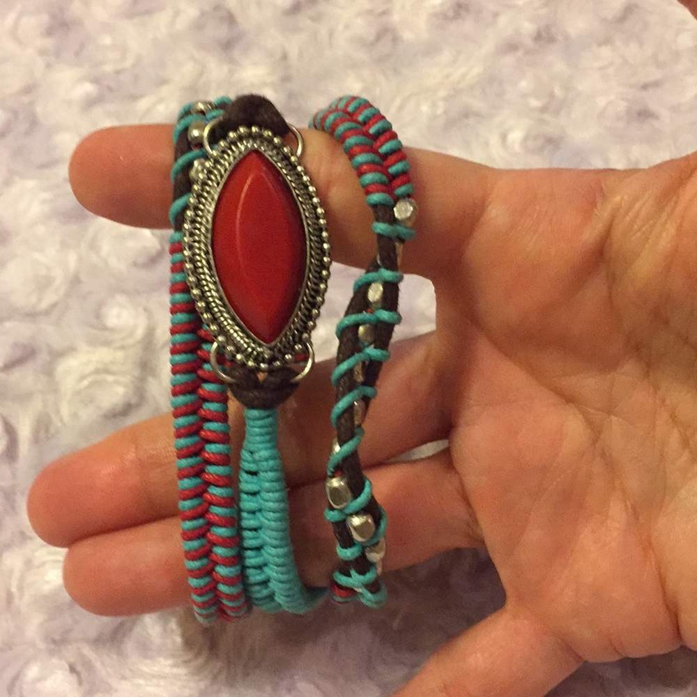 Rope bracelet with red stone.
